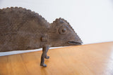 Detailed profile of the vintage African chameleon's head showing etched texture and a round eye.