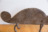 The hand-carved coiled tail and textured, ridged back of the vintage African chameleon figure.