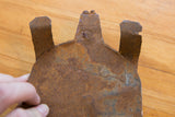 Rustic, textured underside of the handmade African iron turtle collectible.