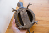 Underside view of the vintage African turtle showing its hollow-body construction.