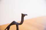 Handmade African camel sculpture head with distinctive dark patina and texture.