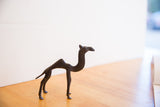 A side profile view of the vintage African camel showing its stylized form and dark patina.