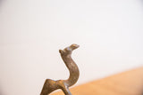 Close-up on the vintage African camel's head, showing its textured, patinated surface.