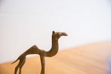 Profile view of a vintage African camel showing its aged surface and handmade details.