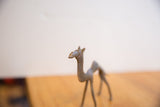 Close-up of the vintage African camel's sculpted head, showing its handmade texture and form.