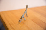 Back view of a vintage African cheetah showing its handmade, oxidized metal form.