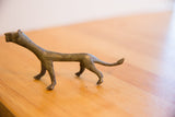 The slender profile of a vintage handmade oxidized cheetah sculpture.