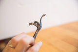 Handmade texture and worn dark patina on the vintage cheetah sculpture's head.