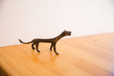 Side profile of a handmade African cheetah sculpture with a dark, textured patina.
