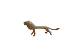 Vintage handmade African lion sculpture with a stylized slender body and oxidized patina.