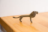 A profile view of the vintage oxidized lion highlights its elongated handmade form.