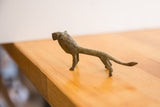 Side view of the handmade African lion showing its oxidized texture and stylized form.