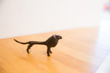 Side view of the vintage African lion sculpture highlighting its dark, textured patina.