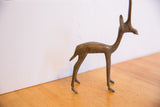 Right side profile of the vintage African gazelle sculpture, showing its aged metal patina.