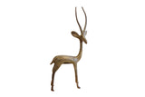 Vintage African gazelle sculpture with a mottled oxidized finish and long curved horns.