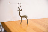 Side profile of a vintage African gazelle sculpture with a dark, oxidized finish.