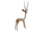 Vintage African right-facing gazelle sculpture with a slender form and aged, oxidized finish.