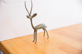 Profile view of the vintage African gazelle highlighting its handmade charm and oxidized patina.