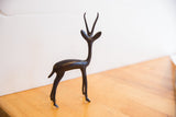 Stylized form of a vintage African gazelle showing its slender body and dark oxidized finish.