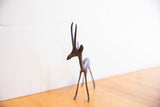 Detailed view of the dark patina and texture on the gazelle's left-facing profile.