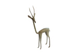 Vintage African gazelle sculpture with a long neck and oxidized green patina, facing left.