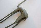 Angled view of the oxidized patina on the vintage gazelle's curved back and hind legs.