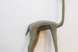 The oxidized finish and smooth contours of the vintage gazelle's hindquarters.
