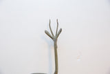 Detail of the slender, three-pronged horns of the vintage oxidized gazelle.