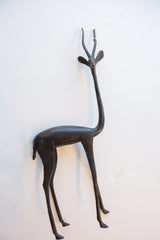 Top-down view of a vintage African gazelle sculpture, highlighting its dark patina and slender shape.