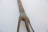 Close-up of the oxidized patina and handmade texture on the vintage giraffe sculpture.