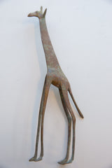 Overhead view of the handmade oxidized giraffe's slender and stylized body.