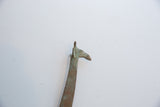 Close-up on the head of a vintage oxidized giraffe, showing its green and brown patina.