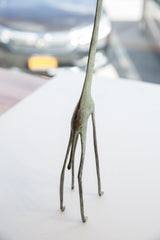 Slender legs and lower body of the vintage African giraffe with time-softened patina.