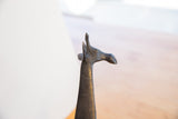 Sculpted head of a vintage African giraffe, showing the dark patina and detailed ears.