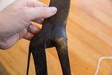 Etched patterns and dark, smooth patina on the back of the vintage African giraffe figure.