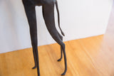 Vintage African giraffe figure's dark, textured legs and tail with patina.