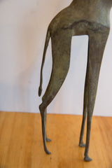 Lower body and slender legs of the vintage African giraffe, showcasing its rich patina.