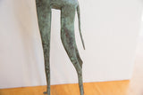 Oxidized green and brown patina on the slender hind legs and tail of the vintage giraffe.