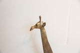 Profile detail of the vintage handmade giraffe's head, highlighting its aged metal finish.