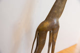 Textured spot patterns and aged patina on the vintage African giraffe's back.