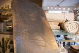 Detail of the vintage hand carved African wooden chair's dark, textured surface.