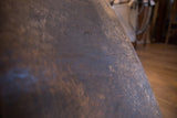Time-softened patina and rich deep brown wood grain on the vintage chair's surface.