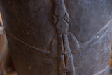 Textured dark wood with hand-carved animal motif on the vintage African chair.