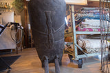 Dark hand-carved wood texture and a leg of the vintage African slot chair.