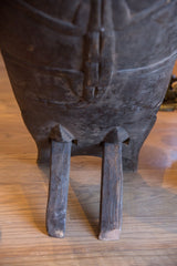 Vintage carved wooden slot chair's rustic legs showing aged wood texture.