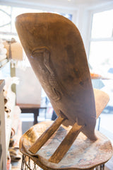 Hand-carved bird with crosshatch pattern on the back of the vintage African chair.