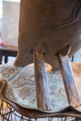Underside view of the vintage African chair showing its slotted leg construction.