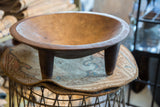 Detailed view of the vintage hand carved wooden bowl's rim with textured patina.
