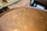 Vintage African wooden bowl interior, warm brown with visible wood grain and crack.