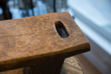 Vintage hand-carved African stool's rich patina and oblong carved opening.